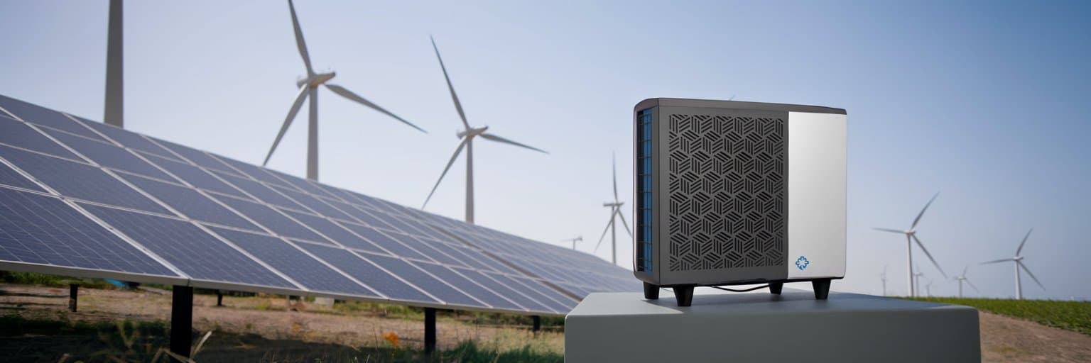 Heatpump in front of solar panels and wind turbines